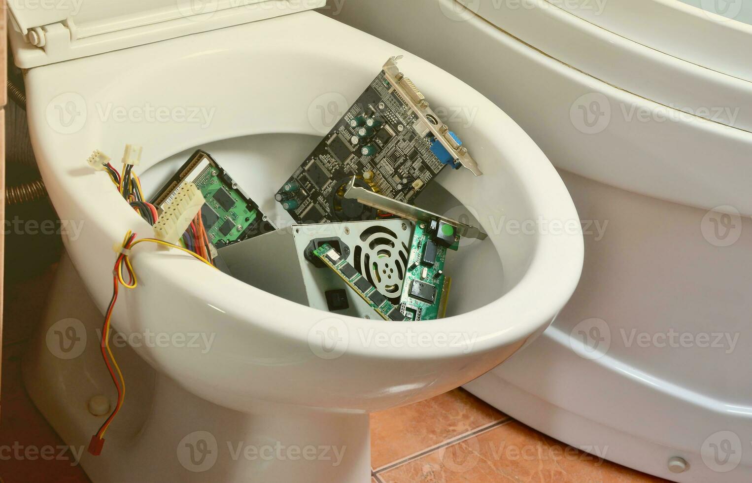 Old and unused computer details is recycled in toilet bowl photo