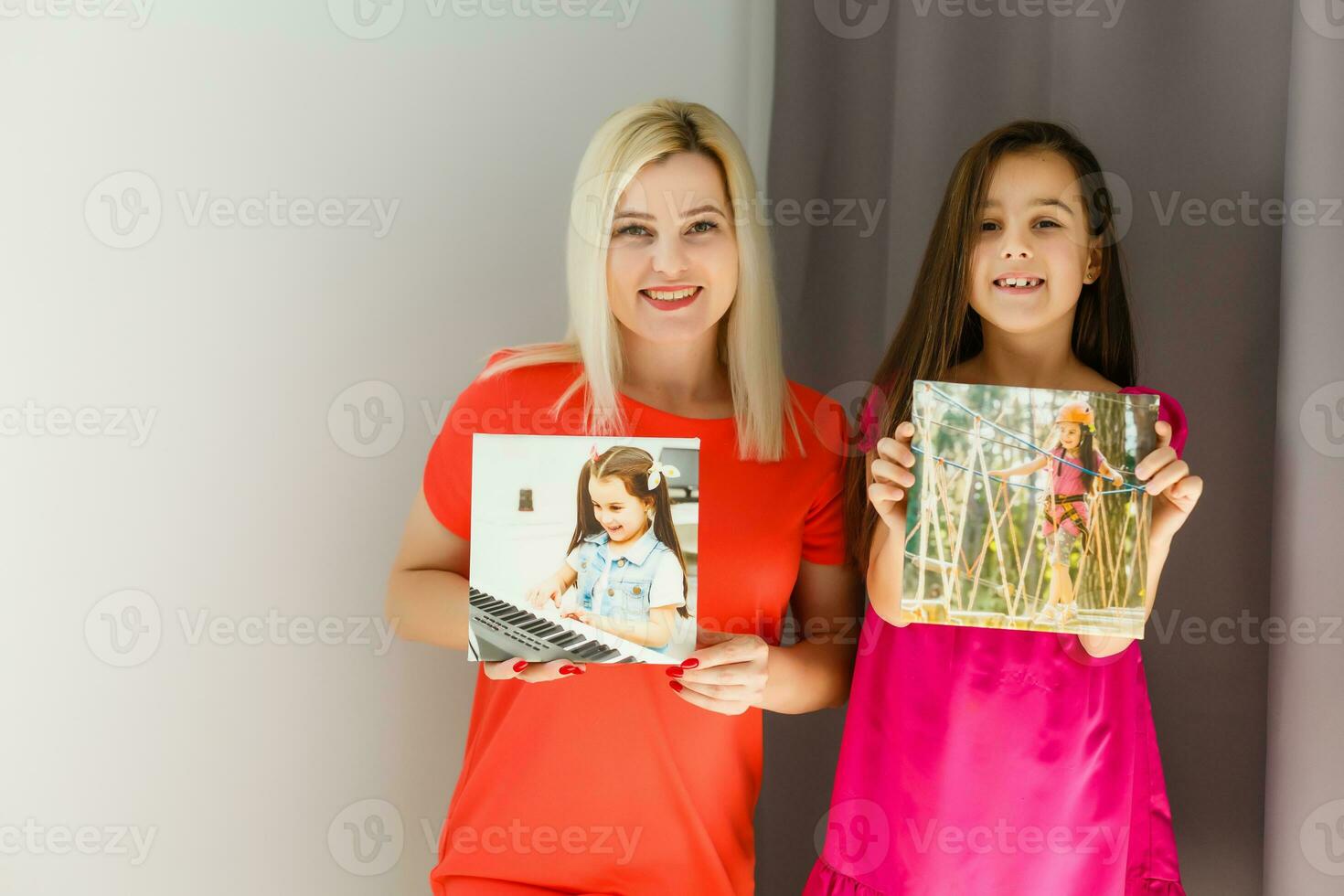 Mother and child hold photo canvas in the interior