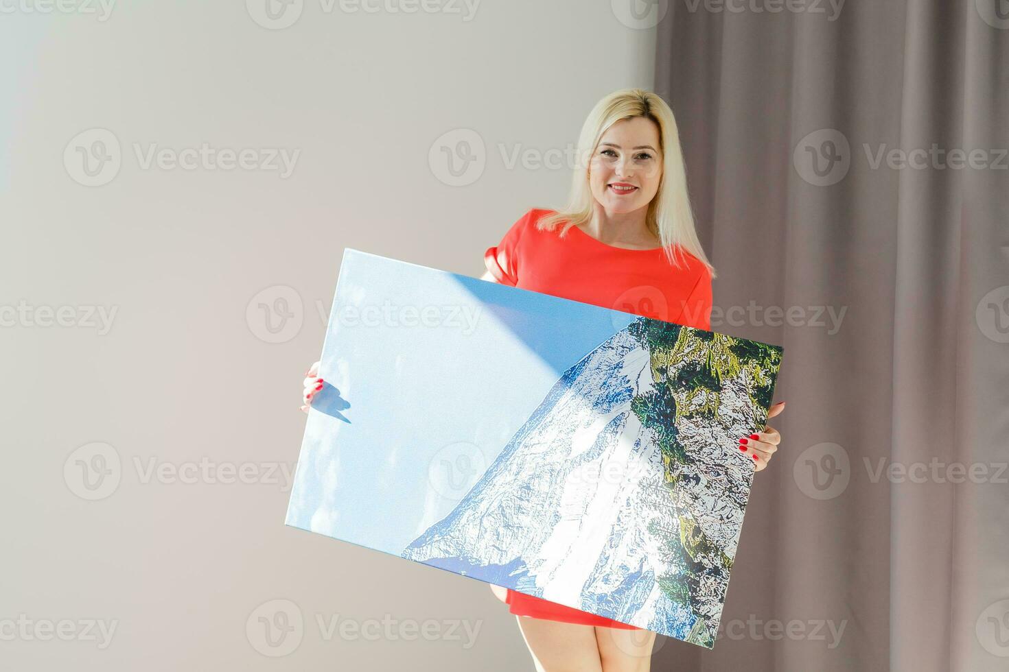 woman holds canvas at home photo