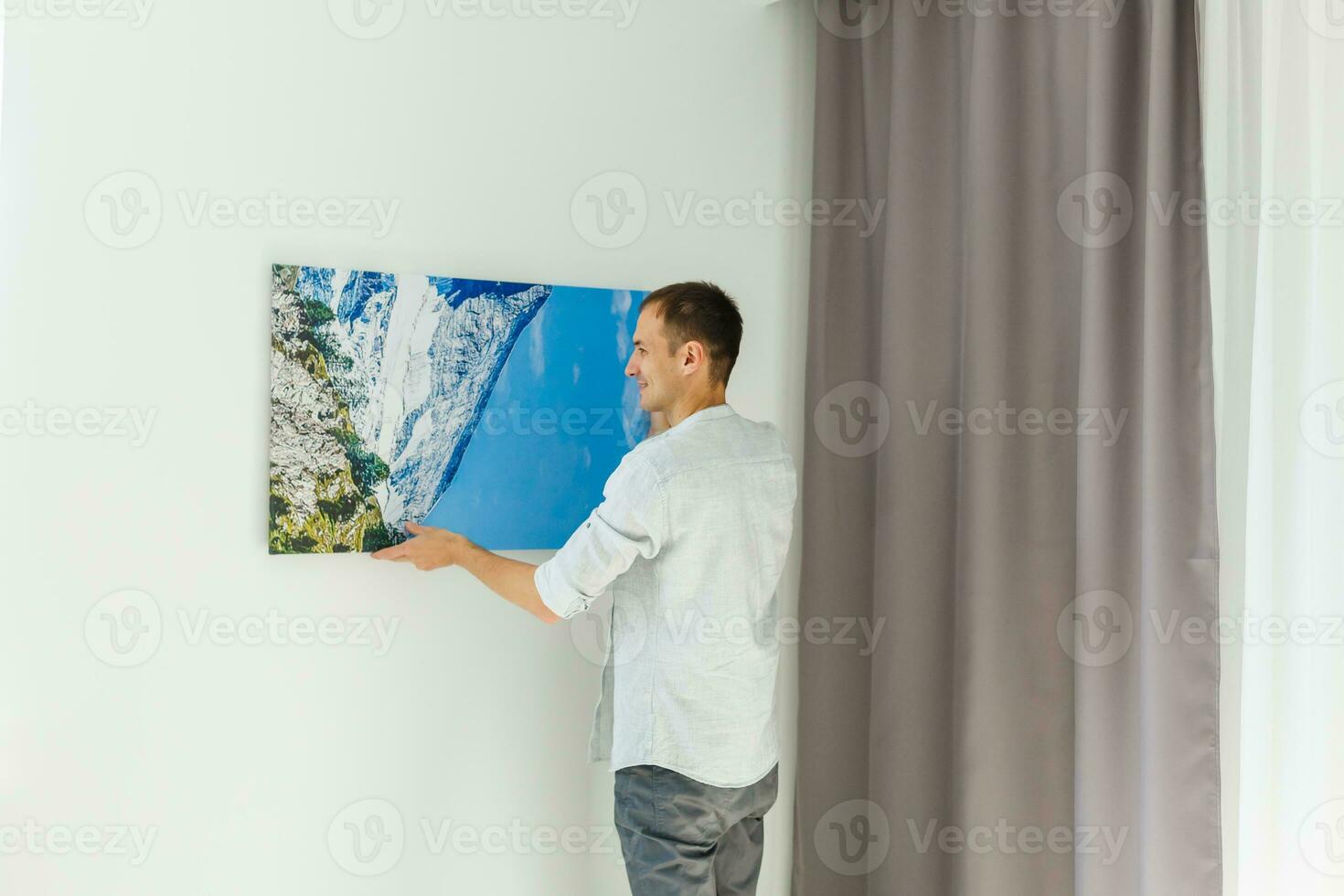 man holds canvas in the interior photo