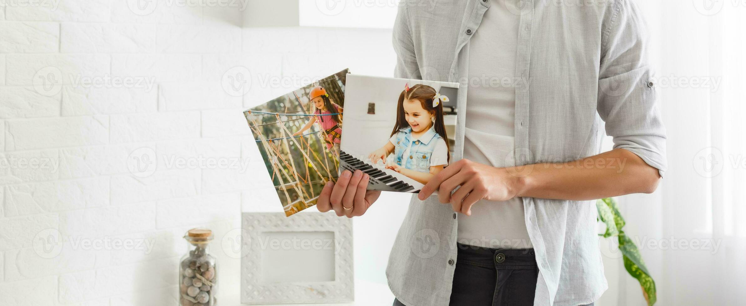 man holds canvas in the interior photo