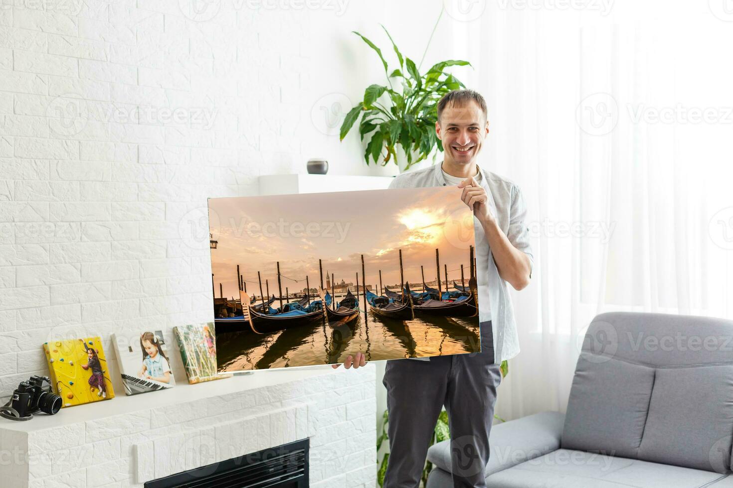 man holds canvas in the interior photo