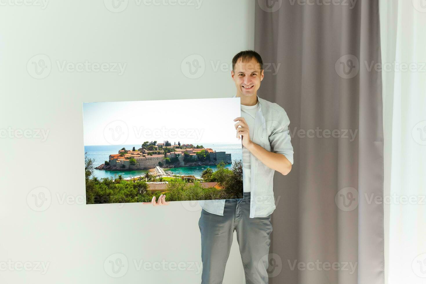 man holds canvas in the interior photo