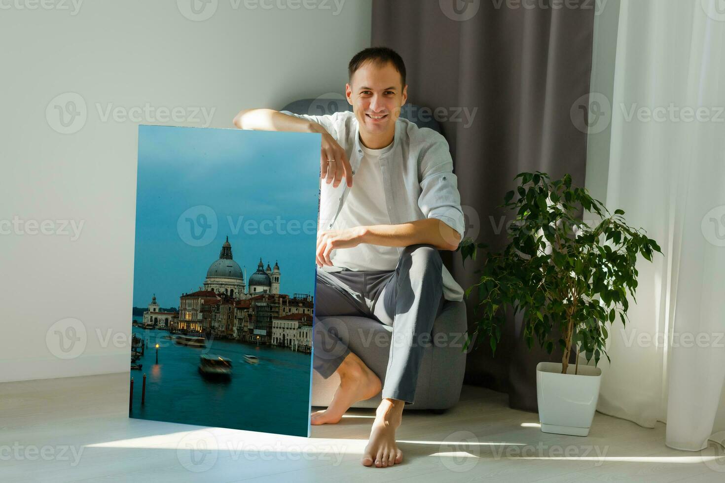 man holds canvas in the interior photo