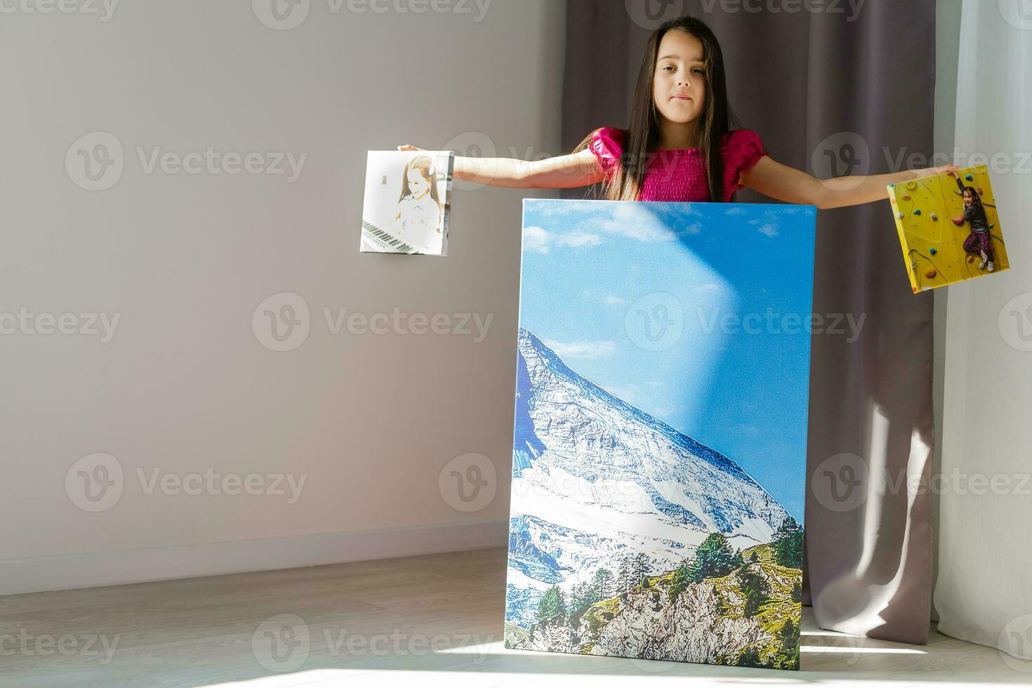 Little girl holding canvas in the interior photo