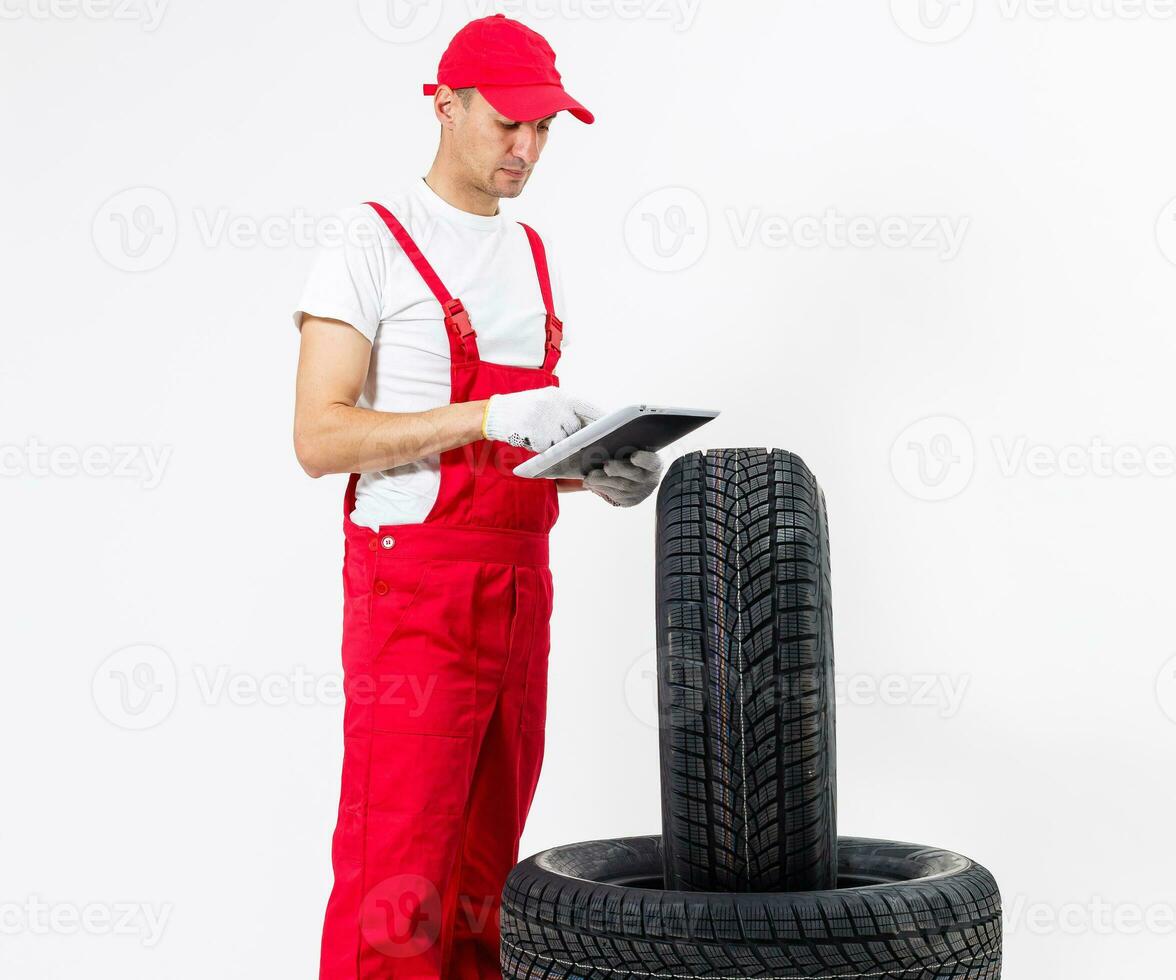 Young mechanic in uniform with a clipboard on white background photo