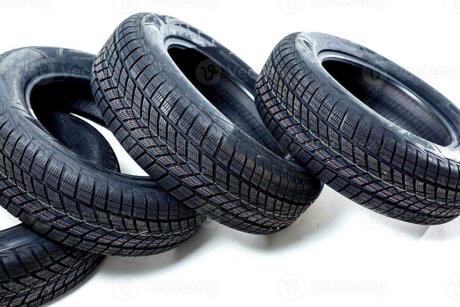 four black tires isolated on white background photo