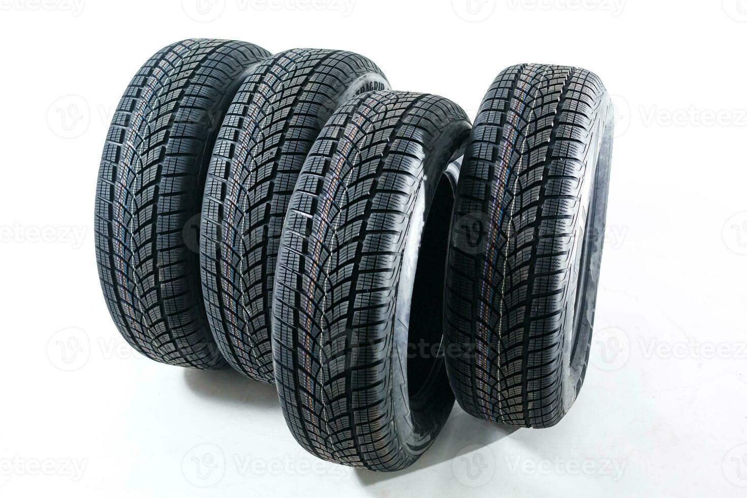 four black tires isolated on white background photo