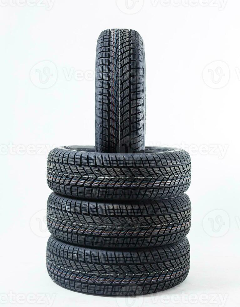 four black tires isolated on white background photo