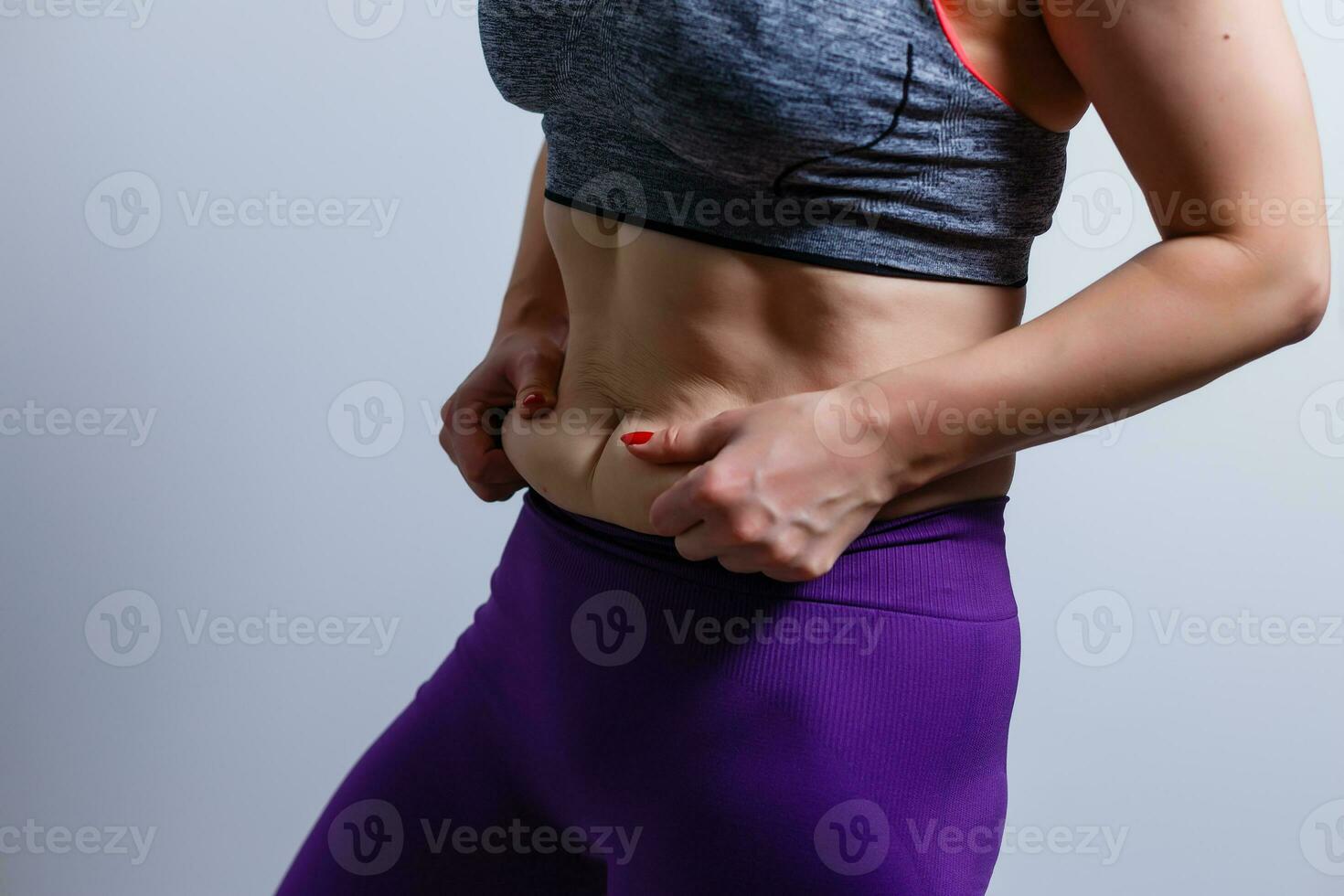 woman pinched her fat on body photo