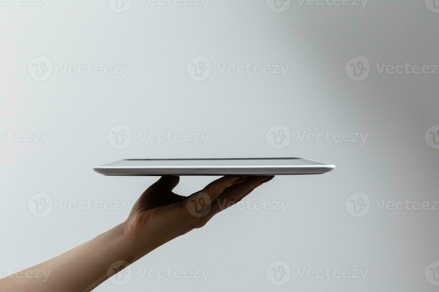 tablet computer isolated in a hand on the white backgrounds. photo