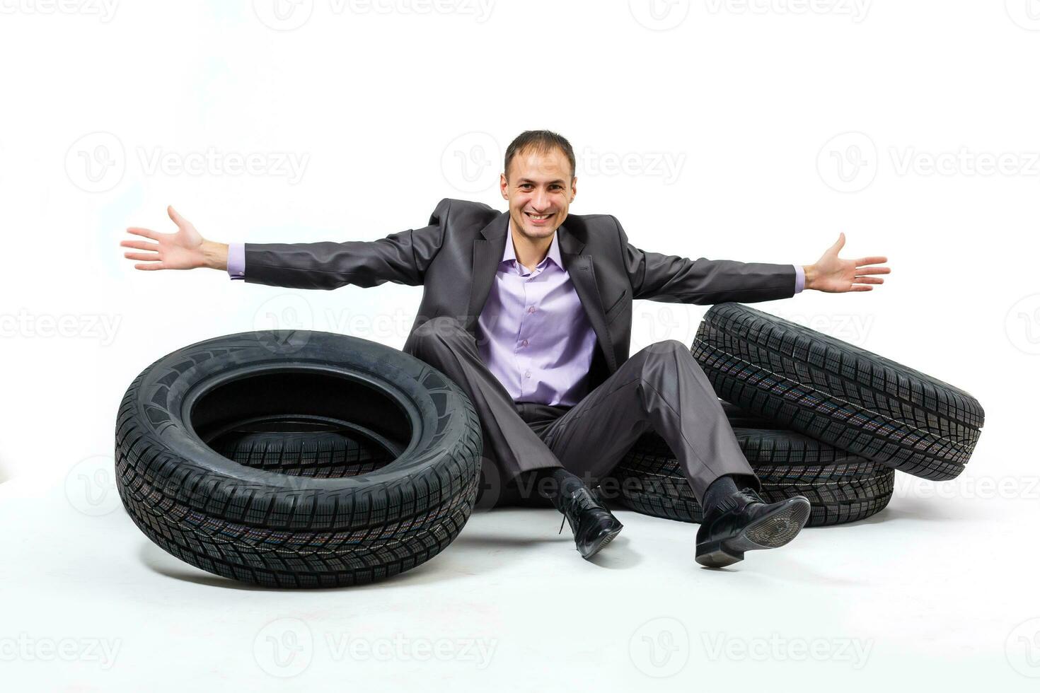 Car dealer man over tire tire background. Auto maintenance. photo