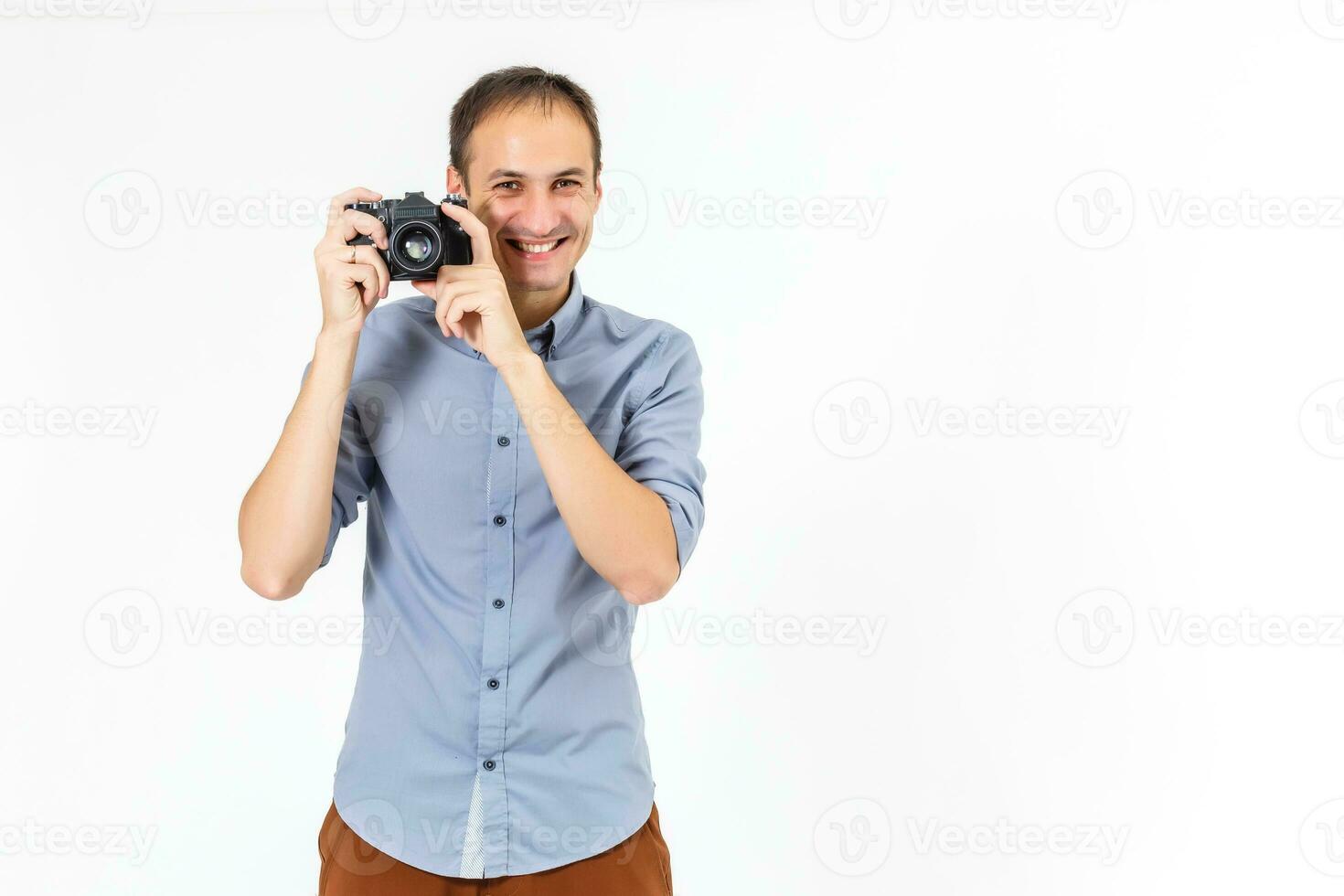 Bend young man taking photo with digital camera side view. isolated over white background.
