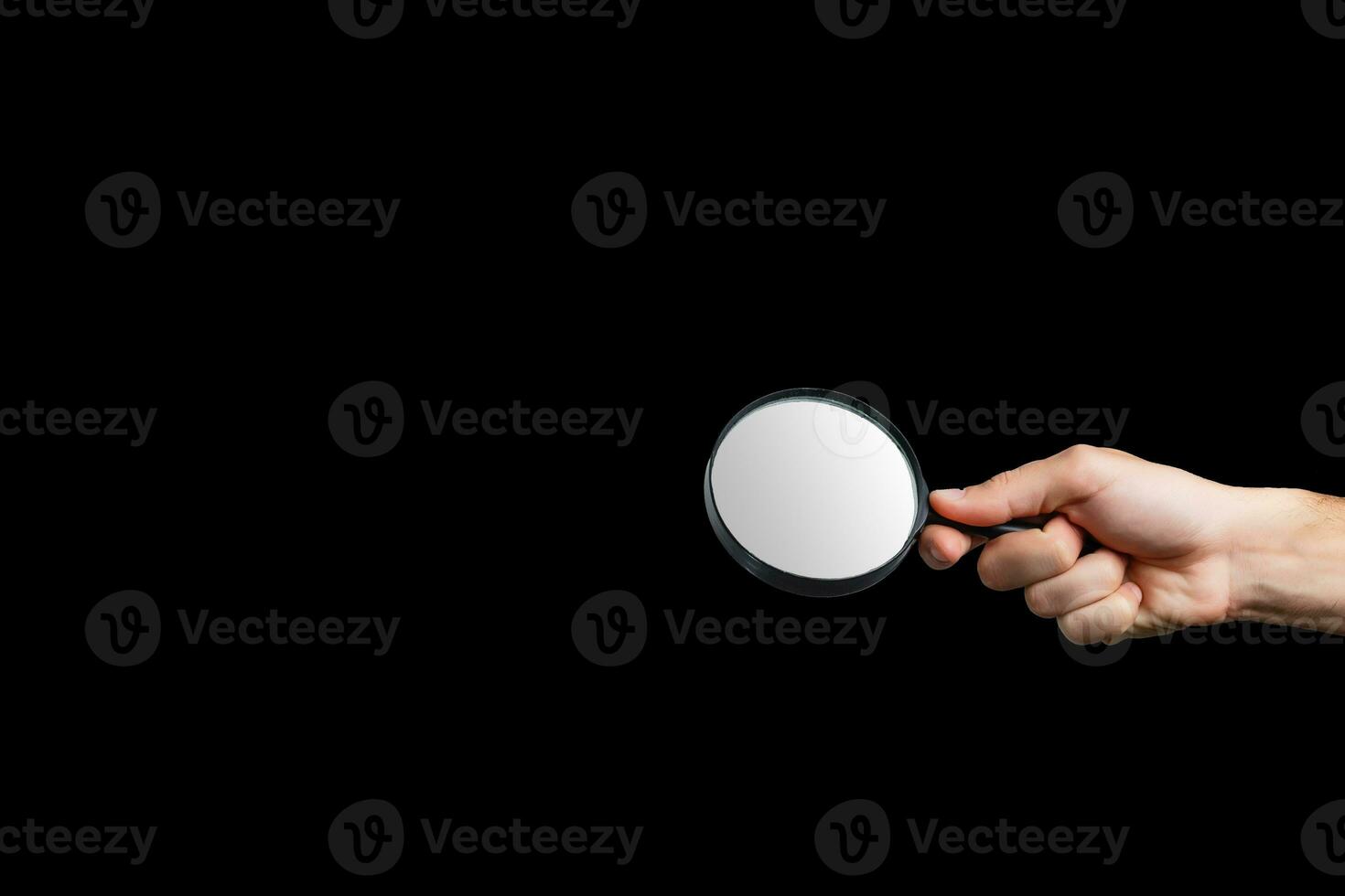 Magnifying glass on a black background photo