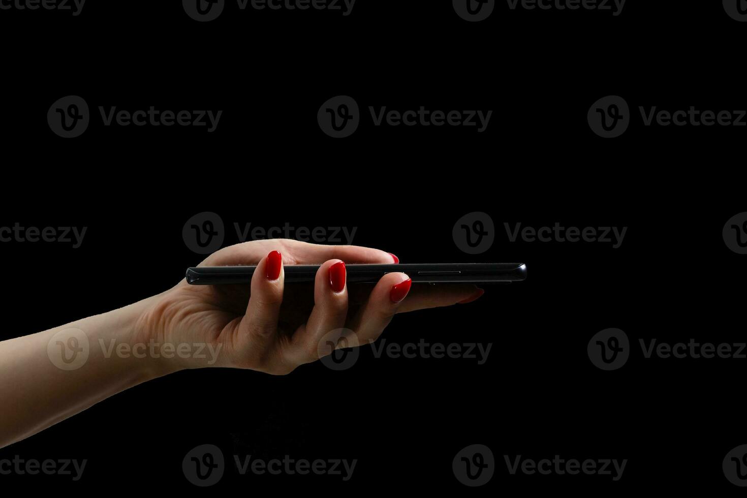 woman hands using modern mobile phone on black background photo