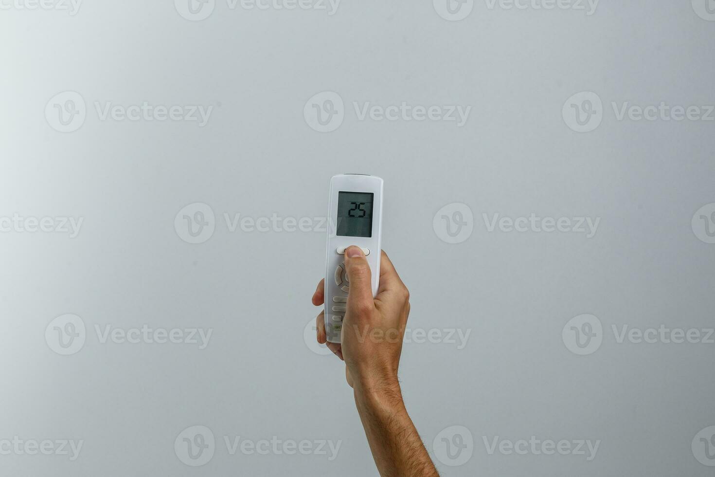 hand holding remote control on white background photo