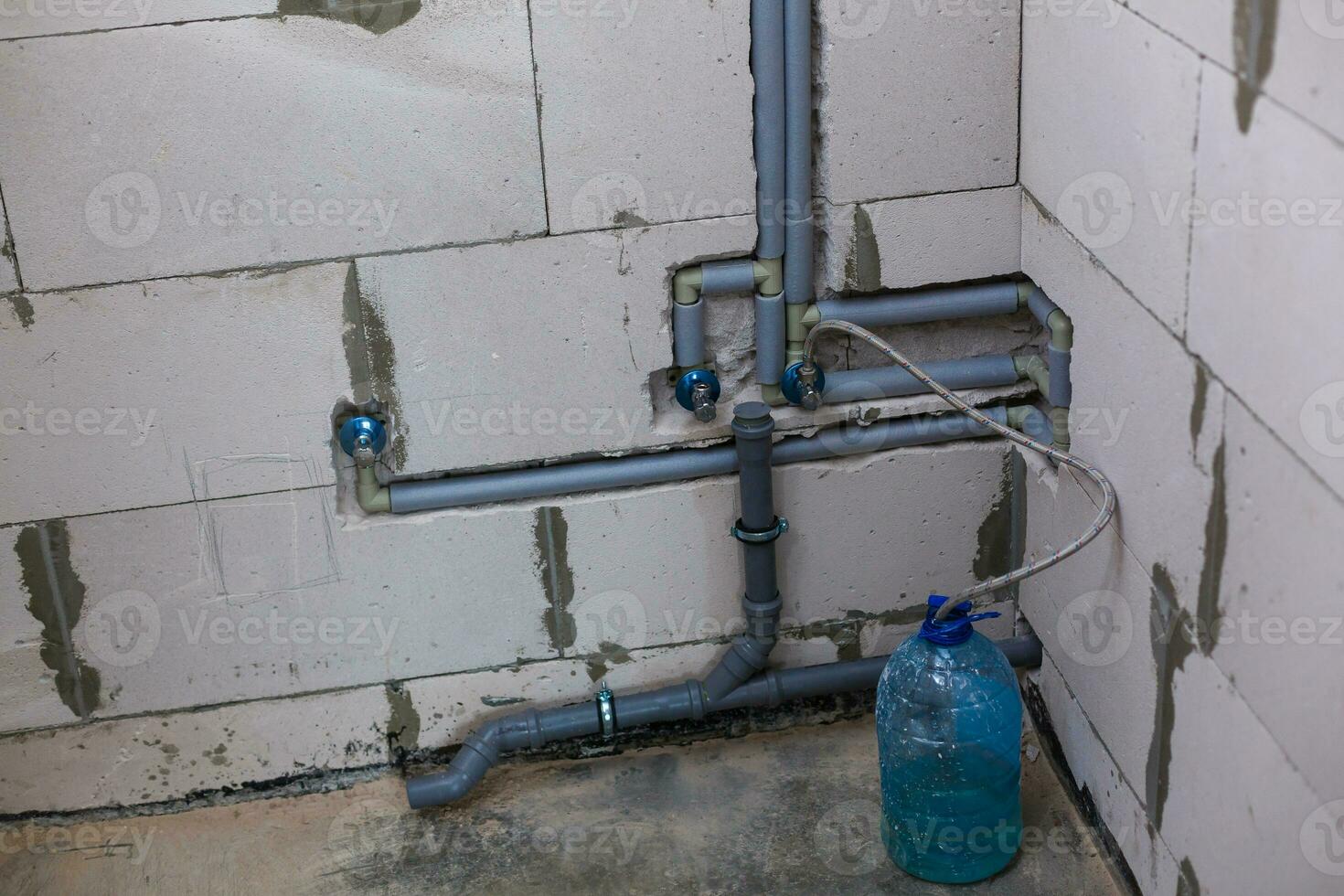 Dismantling and replacing worn-out old sewer pipes in an apartment of a multi-storey residential building. A snapshot of the toilet, the toilet has been dismantled. Sewer riser removed. photo