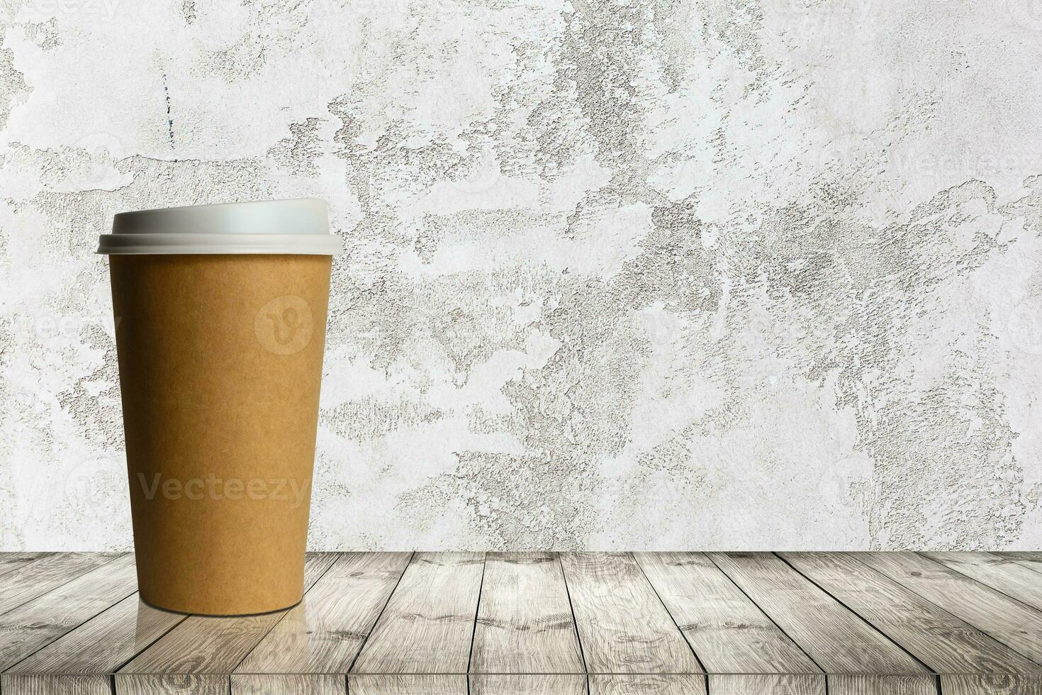 Craft paper coffee cup on a white table near light wall background photo