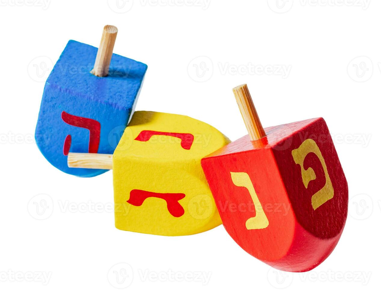 Wooden dreidels for Hanukkah isolated on white or transparent background. photo