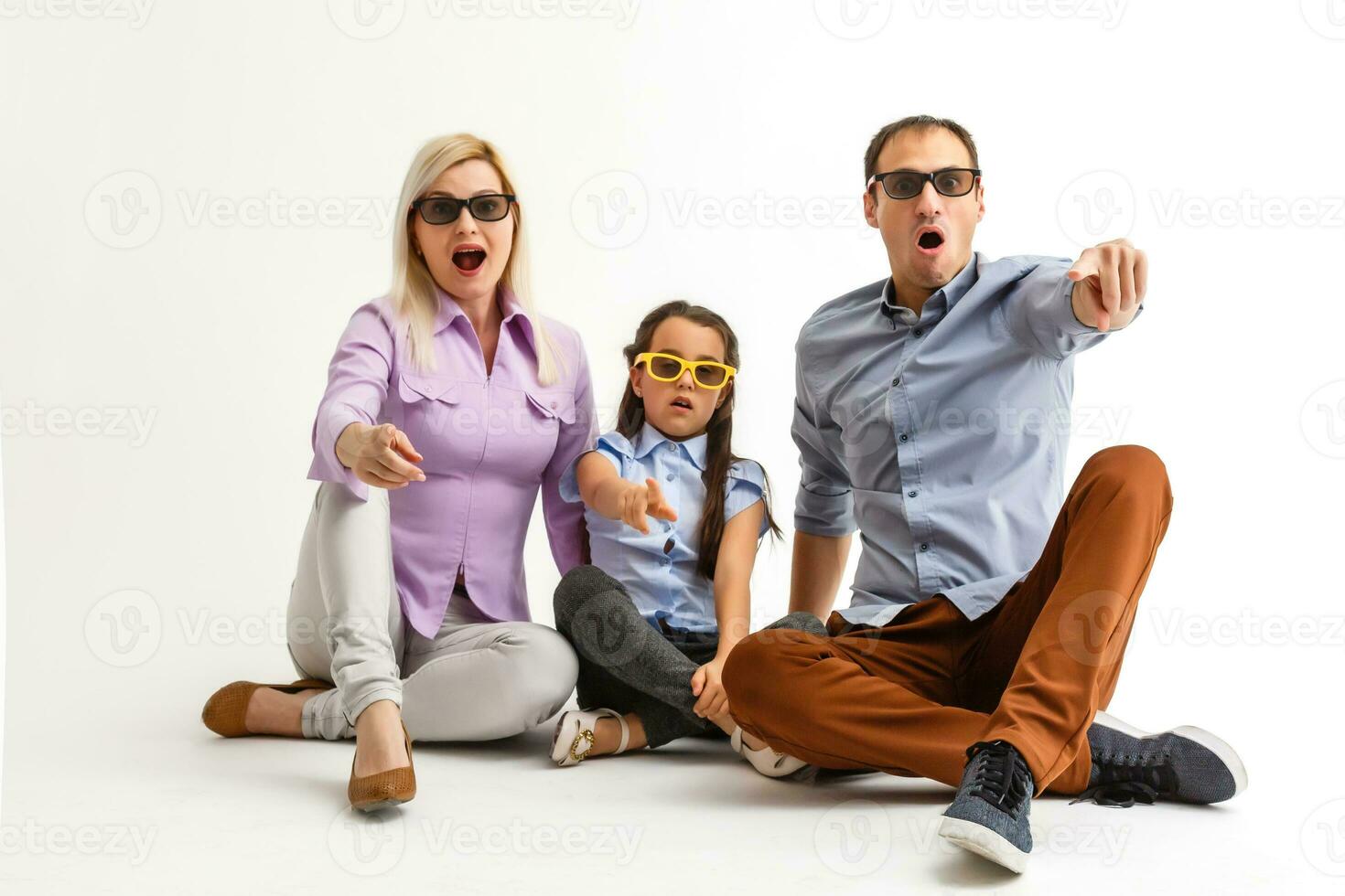 Frightened attractive family wearing casual outfit isolated over white background, watching a movie with 3d glasses photo