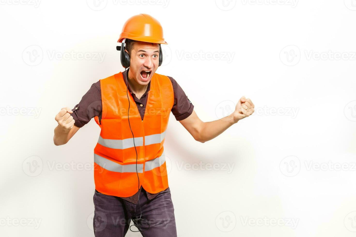 Worker protecting his ears from the noise photo