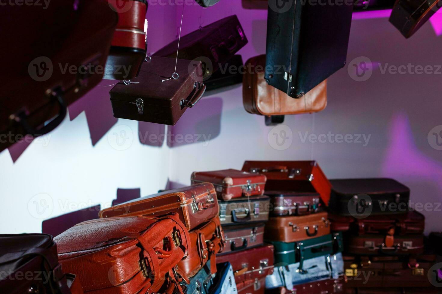 Pile of colorful vintage suitcases. photo