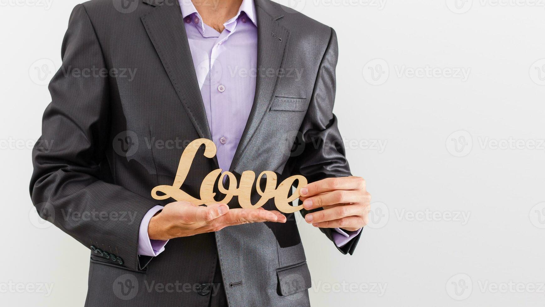 Businessman giving love to a customer on isolated background - customer relationship management photo
