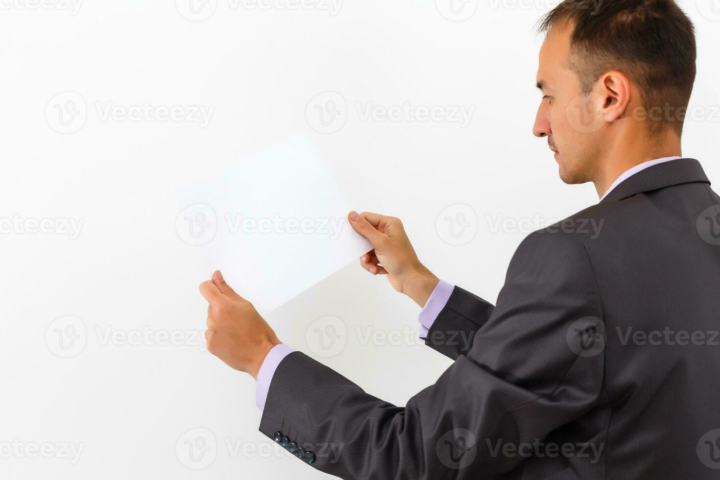 businessman holding a blank white board, signboard, showing an emty bill board against white background photo