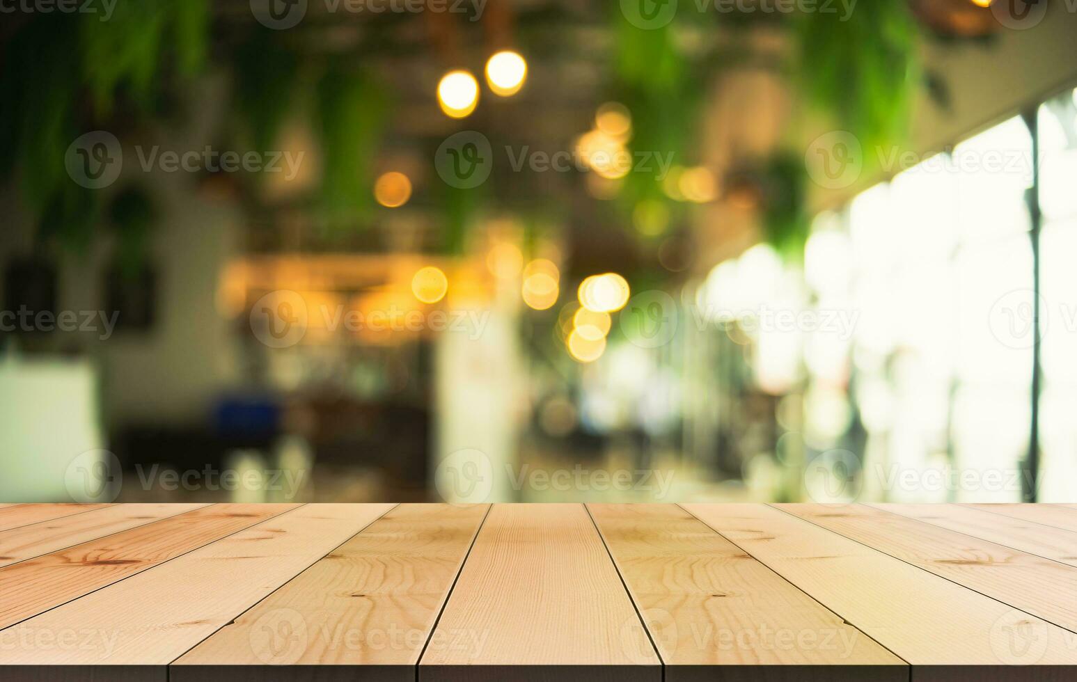 Empty wooden table top with lights bokeh on blur restaurant background photo