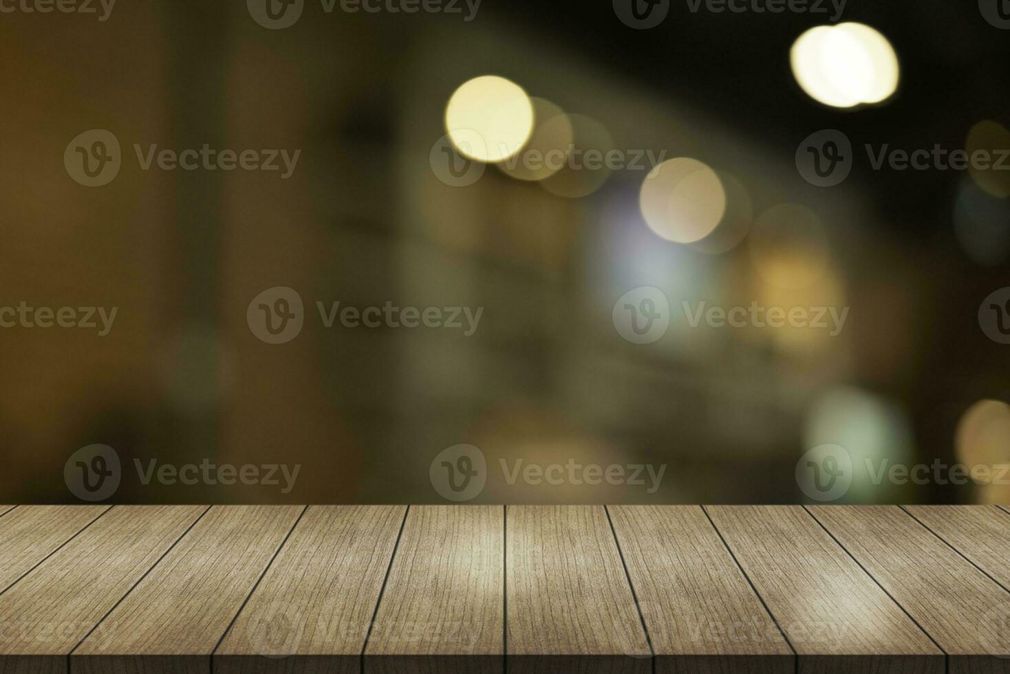 Empty wooden table top with lights bokeh on blur restaurant background. photo