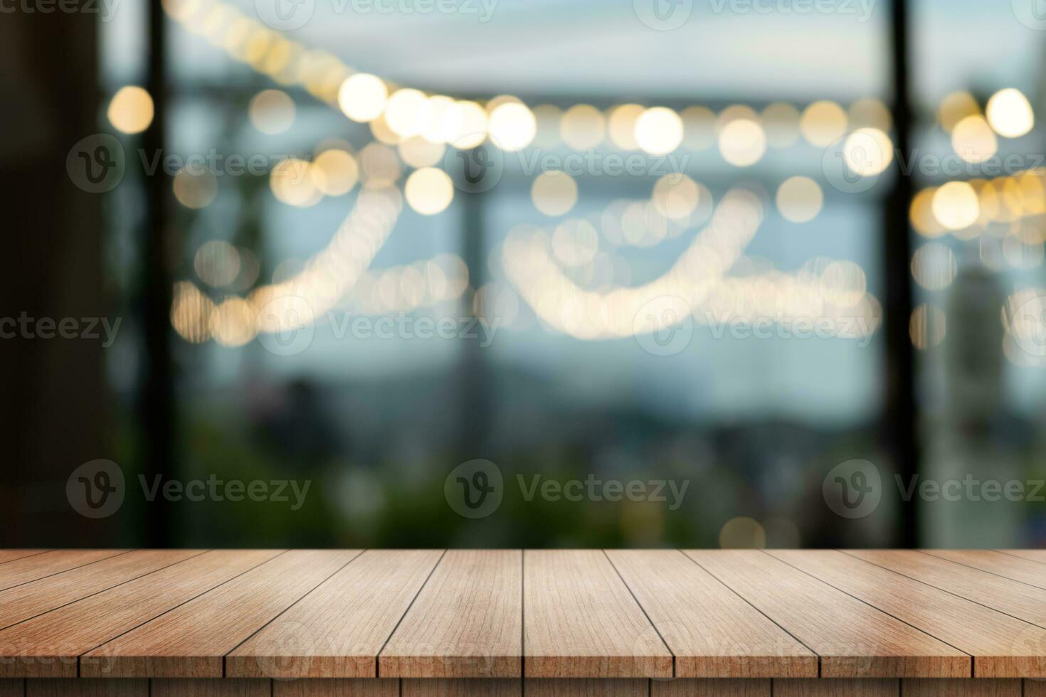 Empty wooden table top with lights bokeh on blur restaurant background. photo