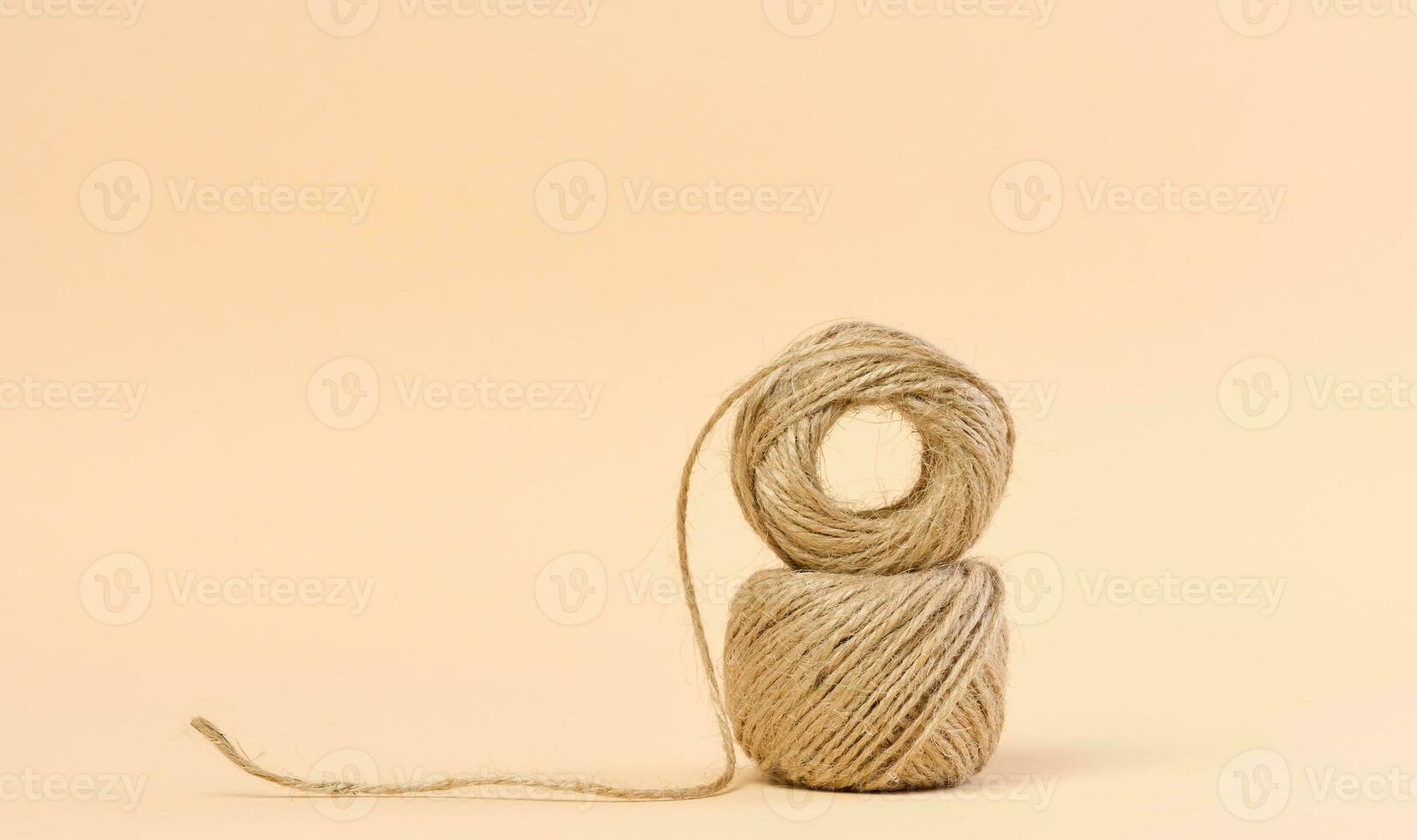 Skein of green and brown thread on a beige background Stock Photo by ndanko