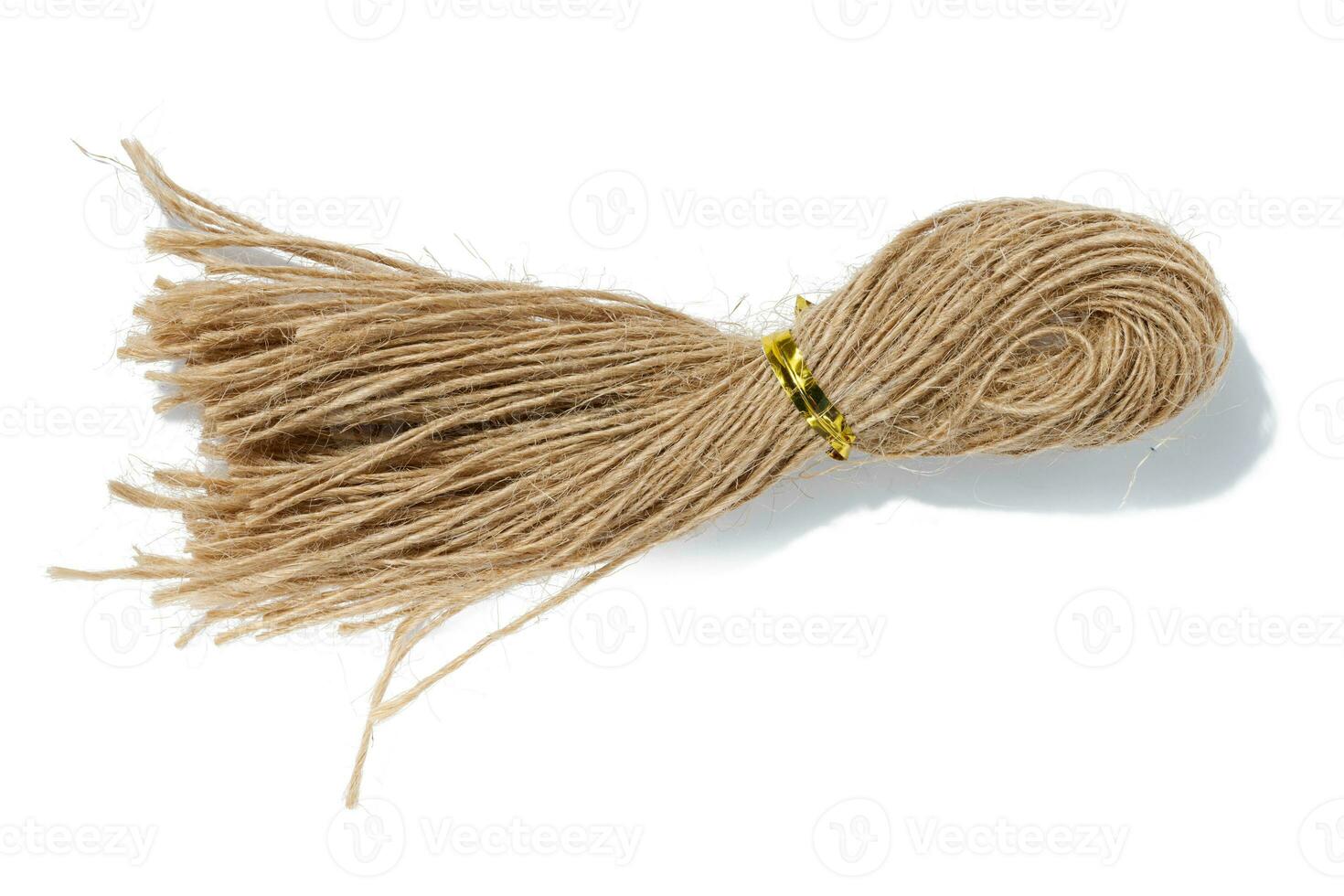 Brown twine rope on a white isolated background, top view. Packing natural photo