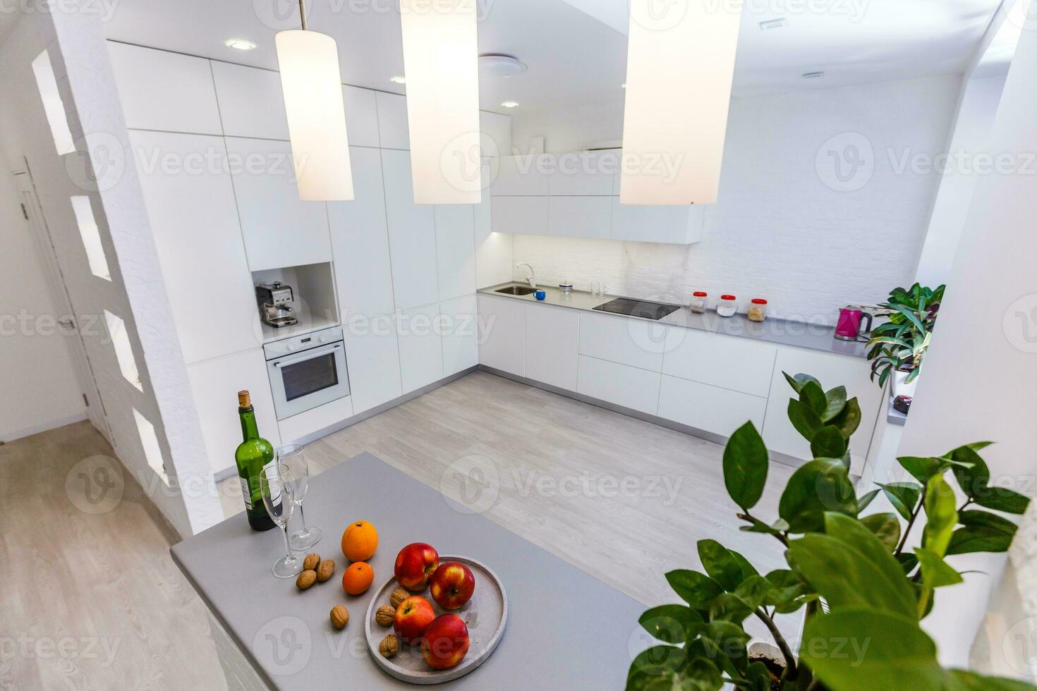 Contemporary modern cream colored luxury kitchen with fitted appliances and breakfast bar photo