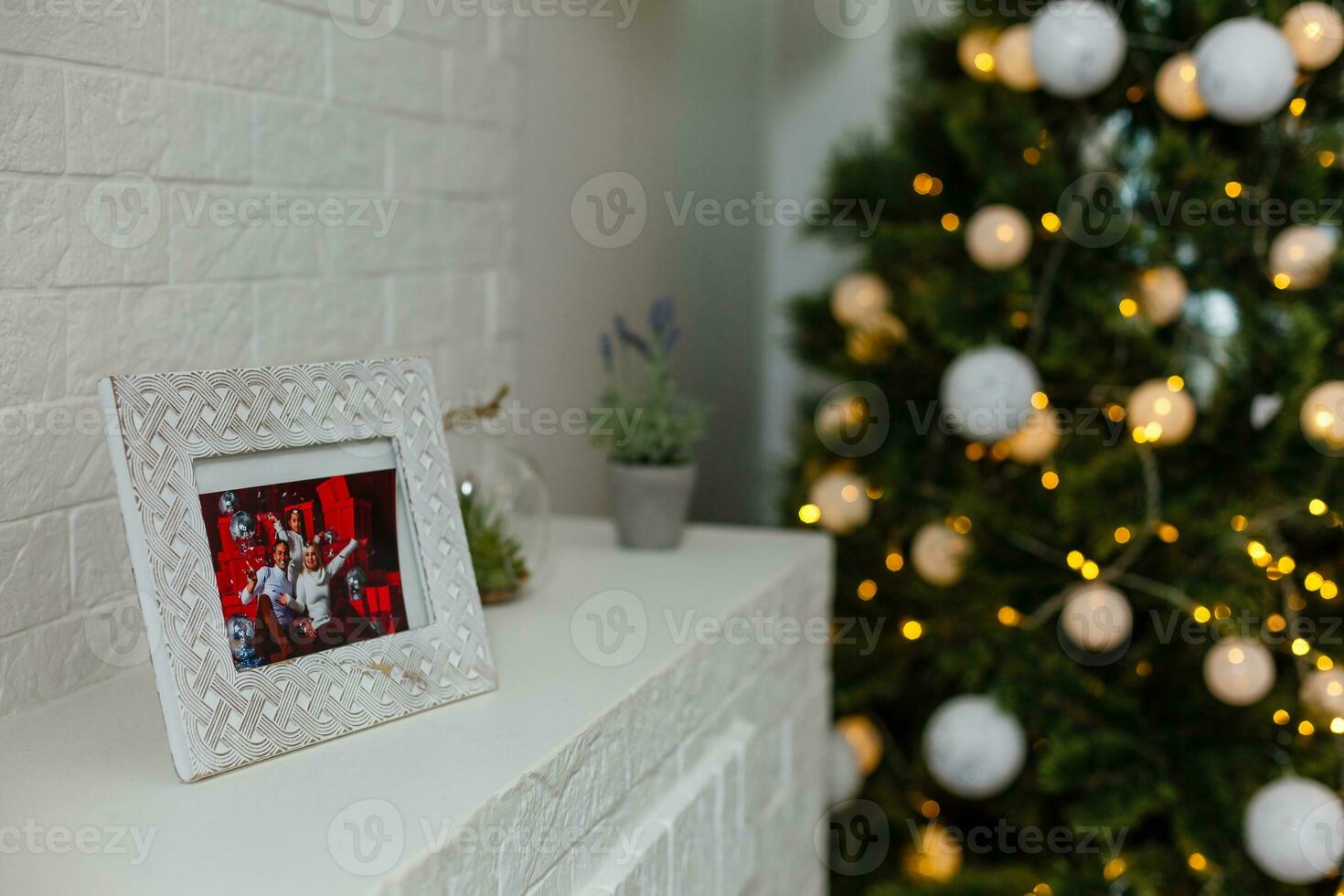 photo frame in front of christmas tree on living room