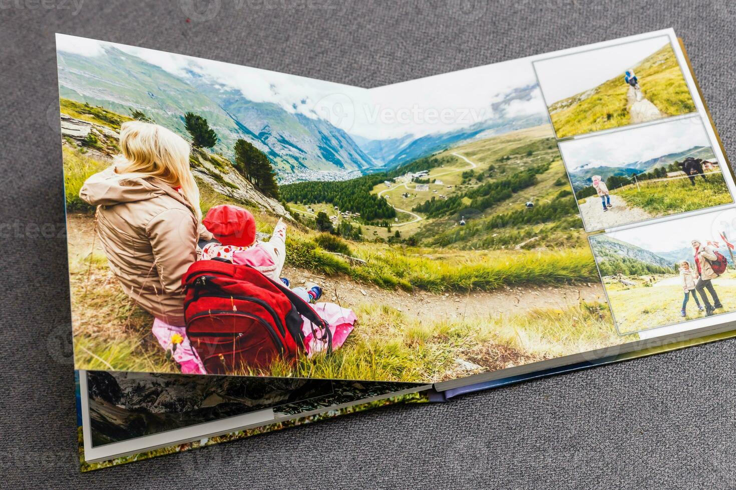 the photobook opened, travel in switzerland, on gray background photo
