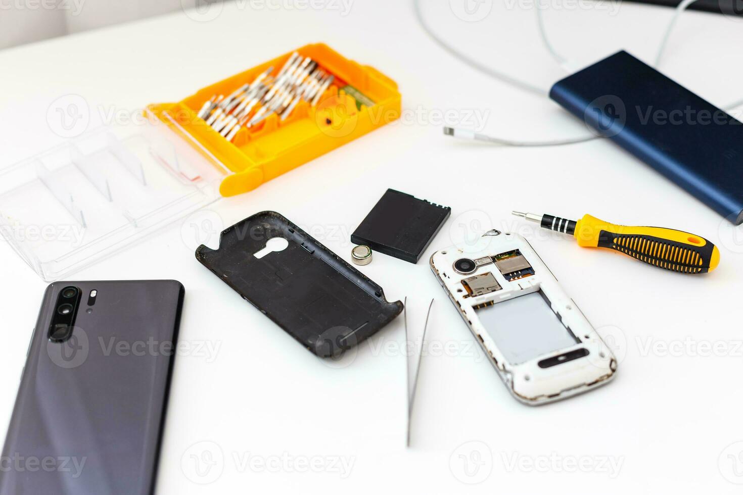 Close-up photos of mobile phones in a repair atelier.