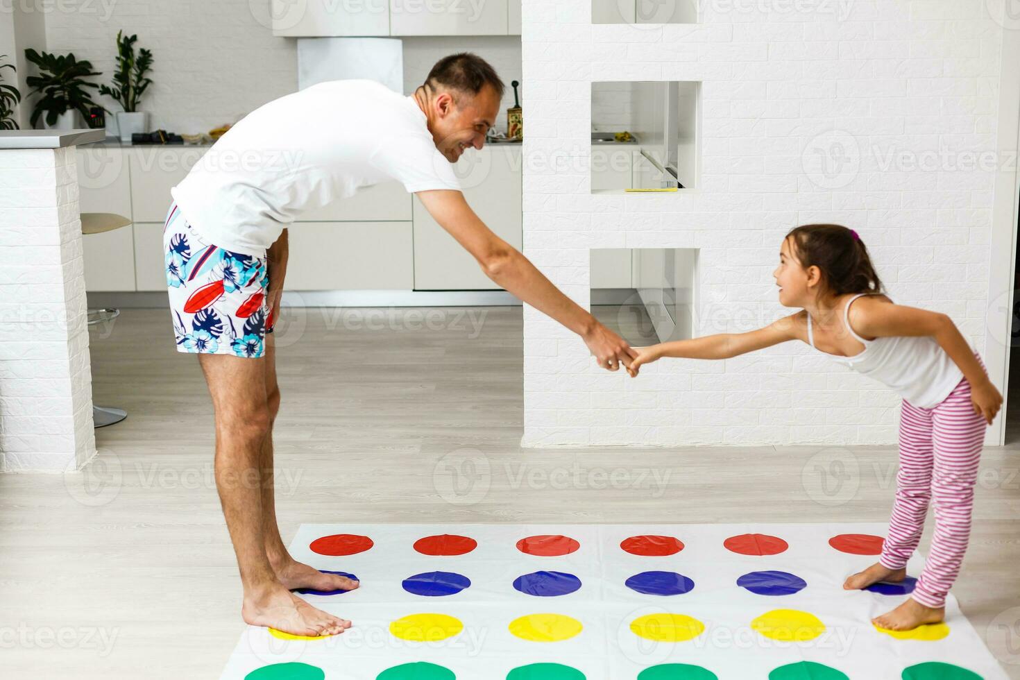 happy family having fun together, playing twister game at home photo