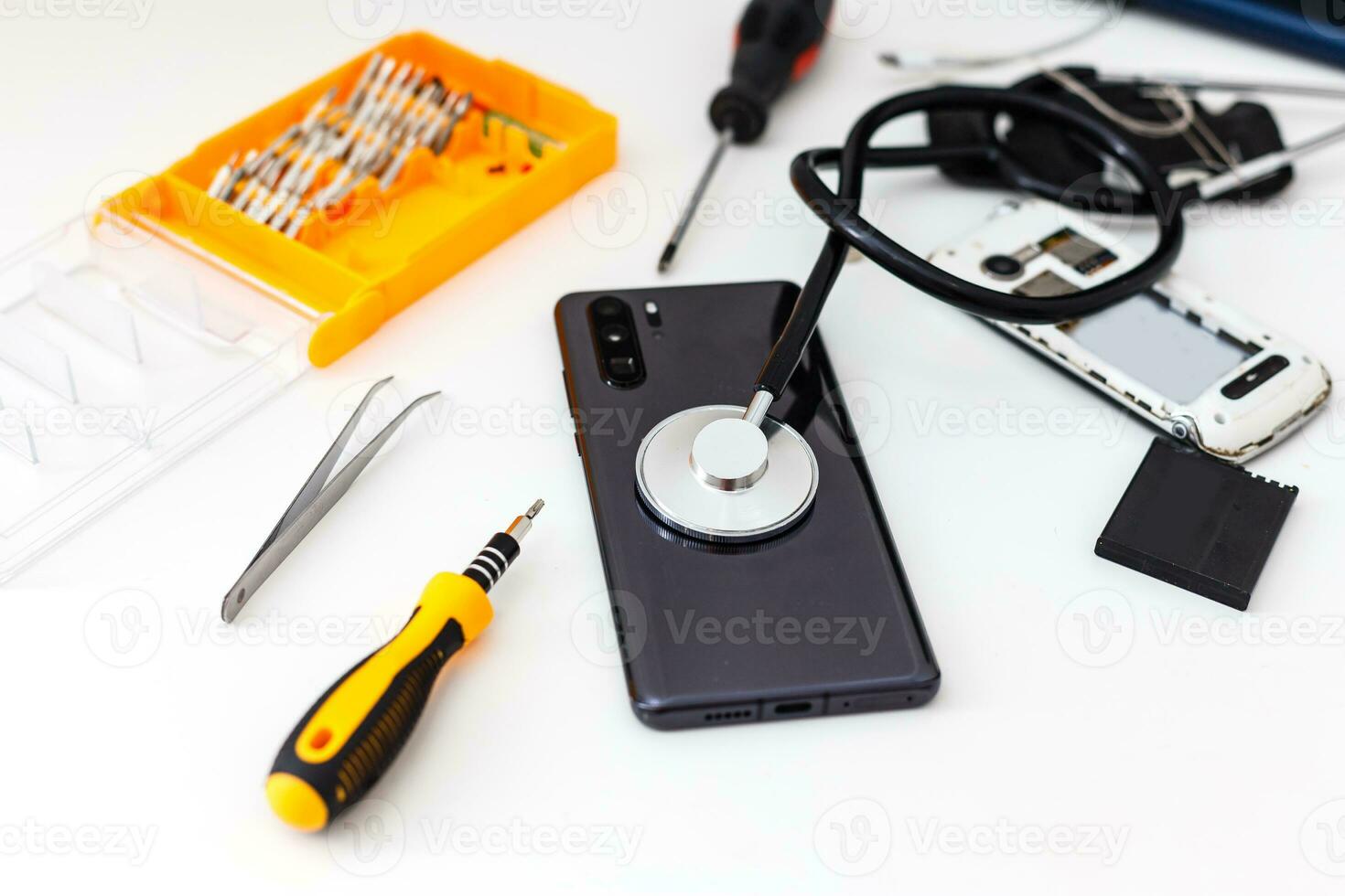 diagnostic of gadgets on white background with stethoscope photo