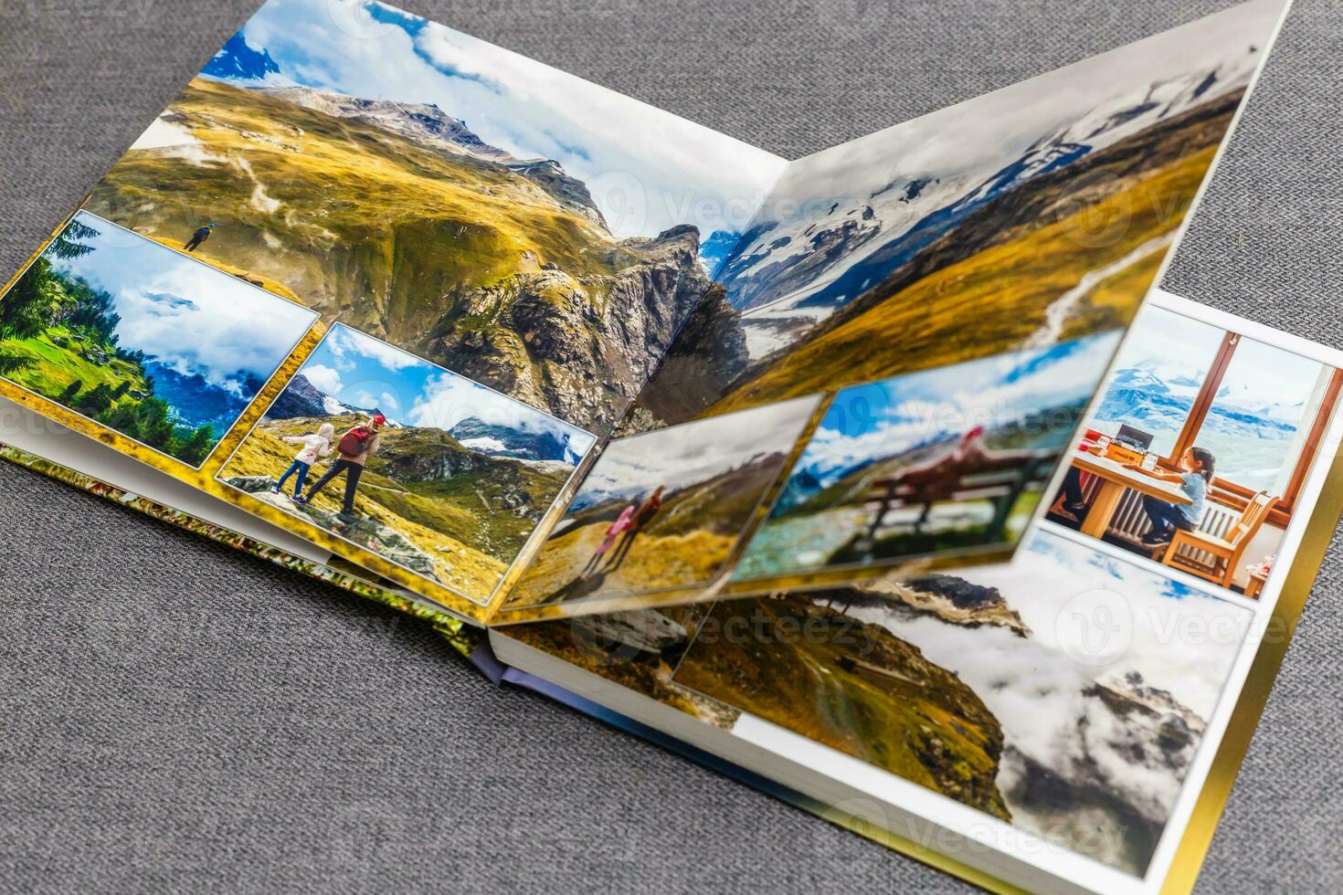 the photobook opened, travel in switzerland, on gray background photo