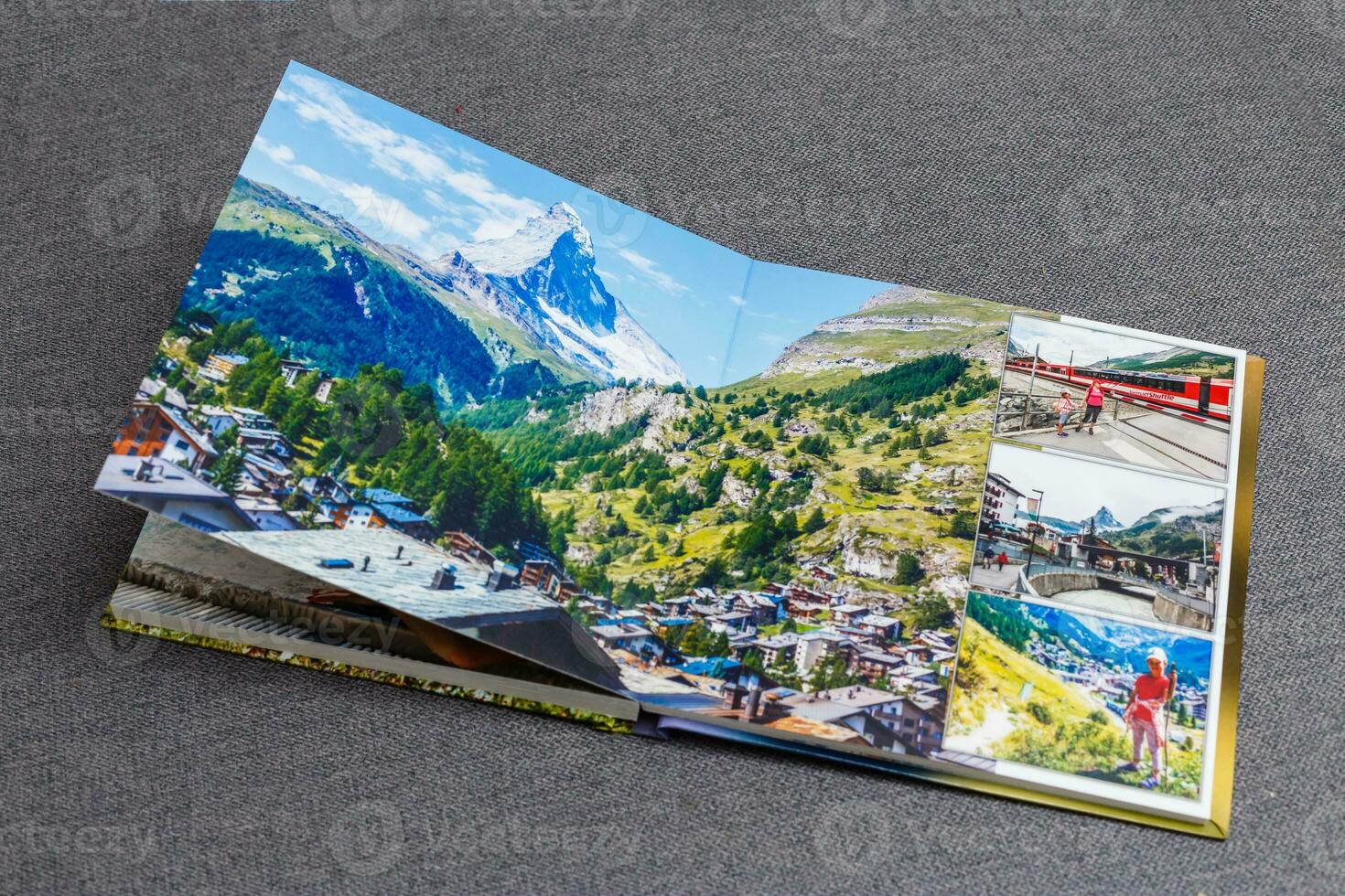 the photobook opened, travel in switzerland, on gray background photo