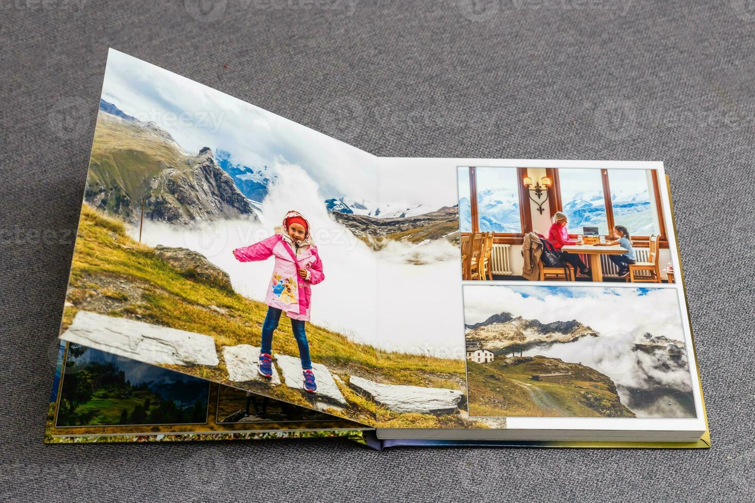 the photobook opened, travel in switzerland, on gray background photo