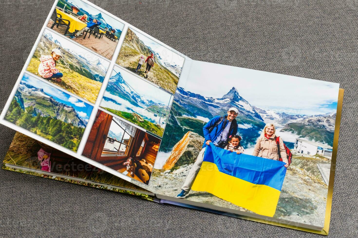 the photobook opened, travel in switzerland, on gray background photo