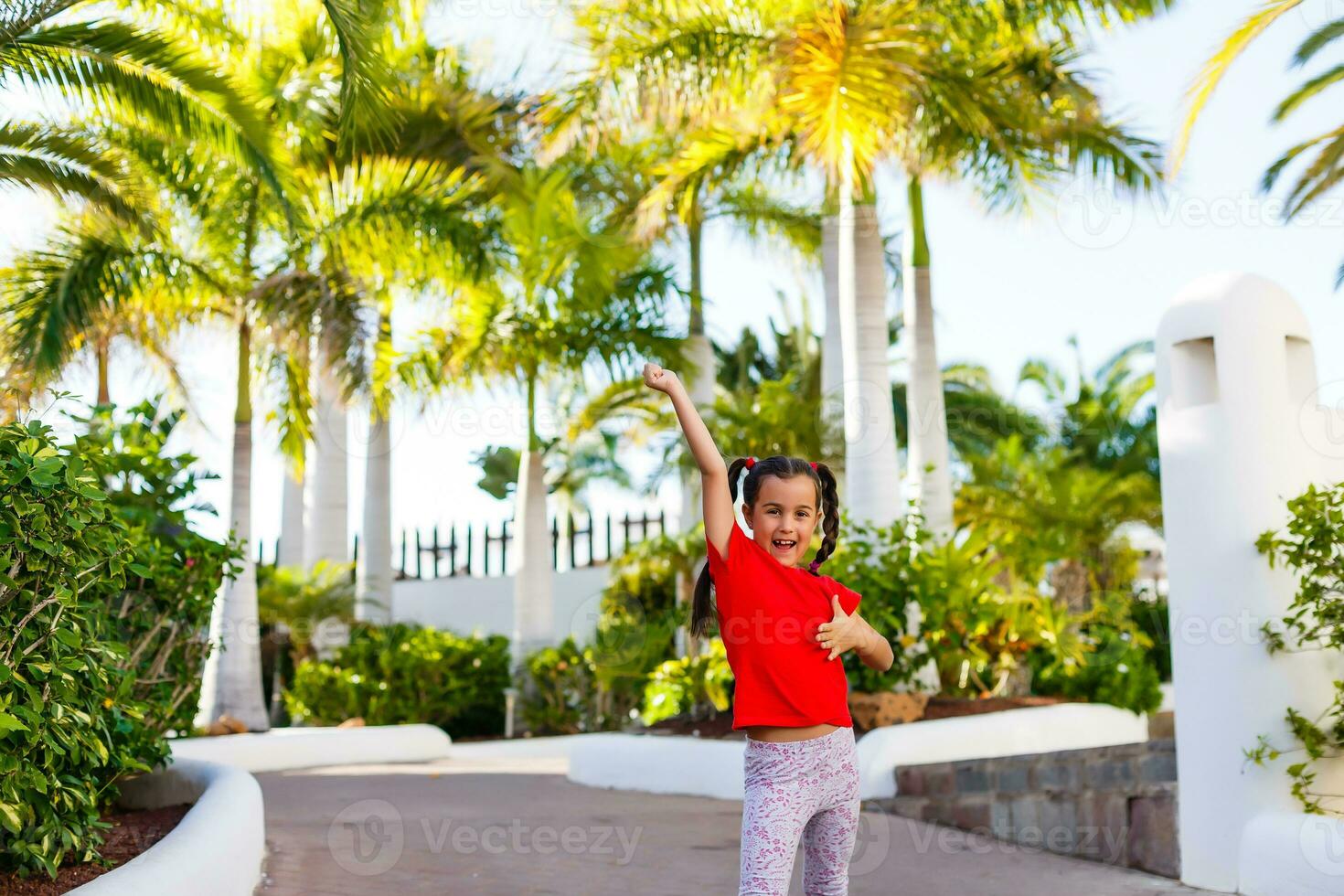 The concept of family happiness and children in the summer on the sea among palm trees. Cute little girl without a pattern. photo