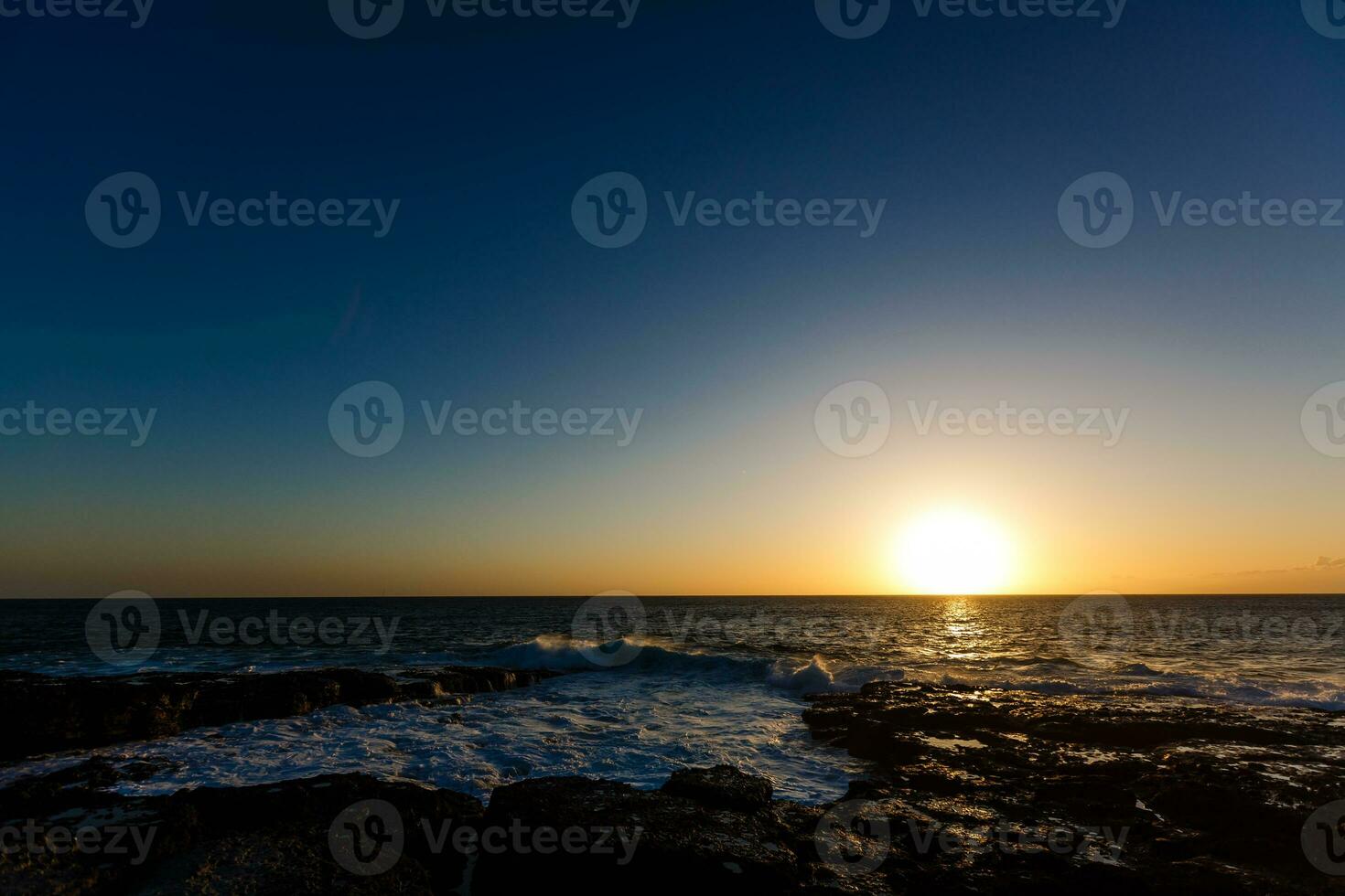 Evening scene on sea, stones, calm ocean photo