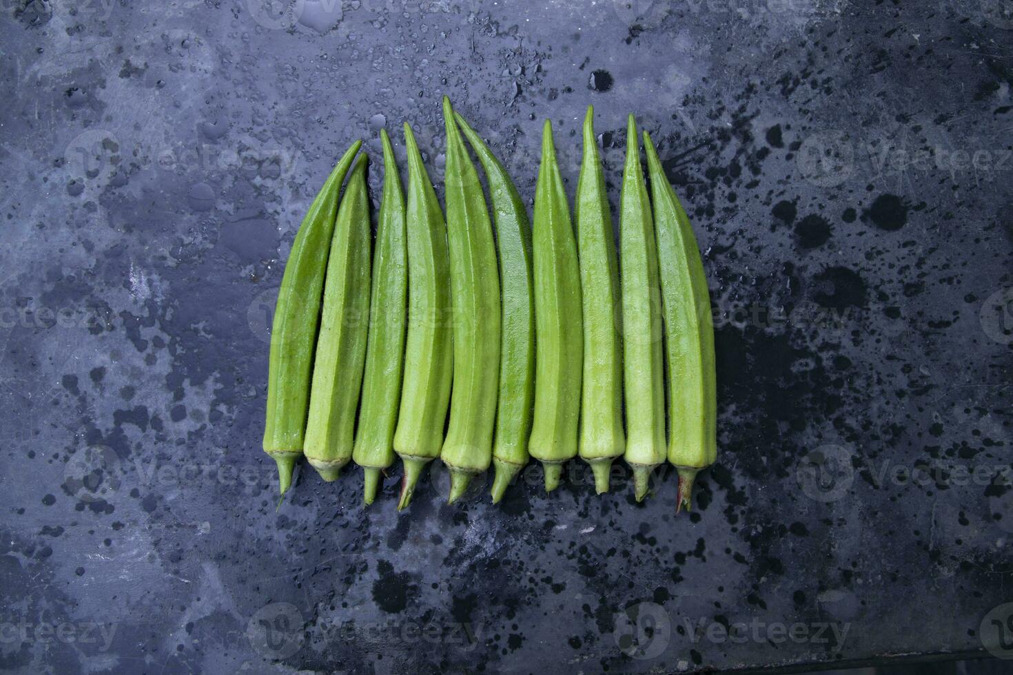 Fresh organic vegetables Lady's Finger or Okra on the Dark concrete floor photo