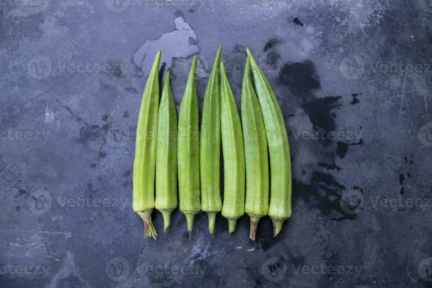 Fresh organic vegetables Lady's Finger or Okra on the Dark concrete floor photo