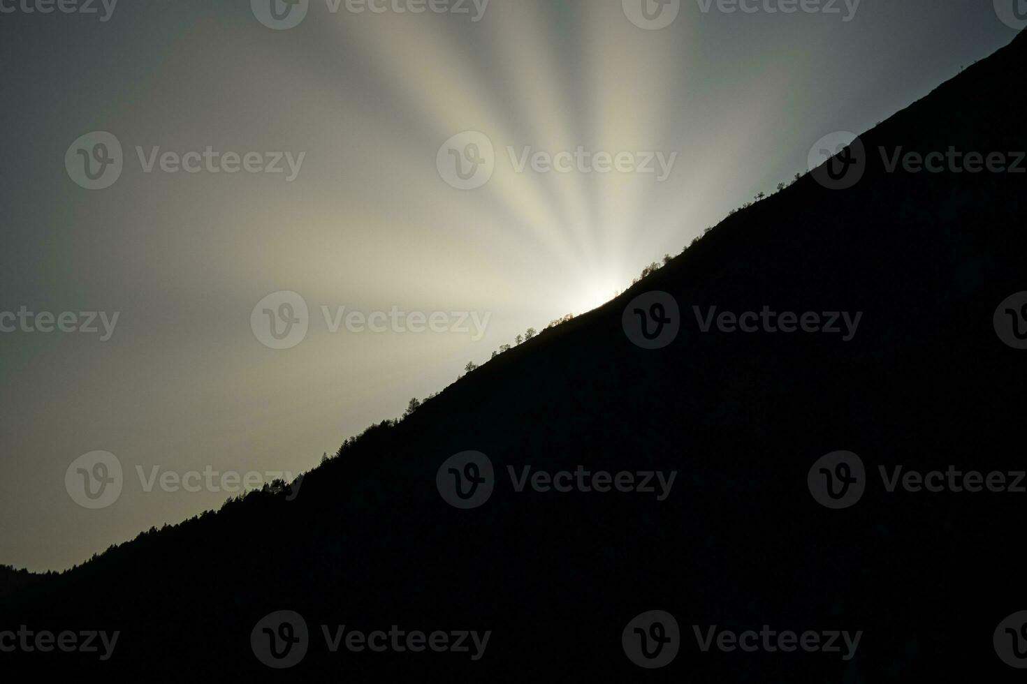 Sunrise on a mountain peak in Norway. The mountain in the shade. Landscape shot photo