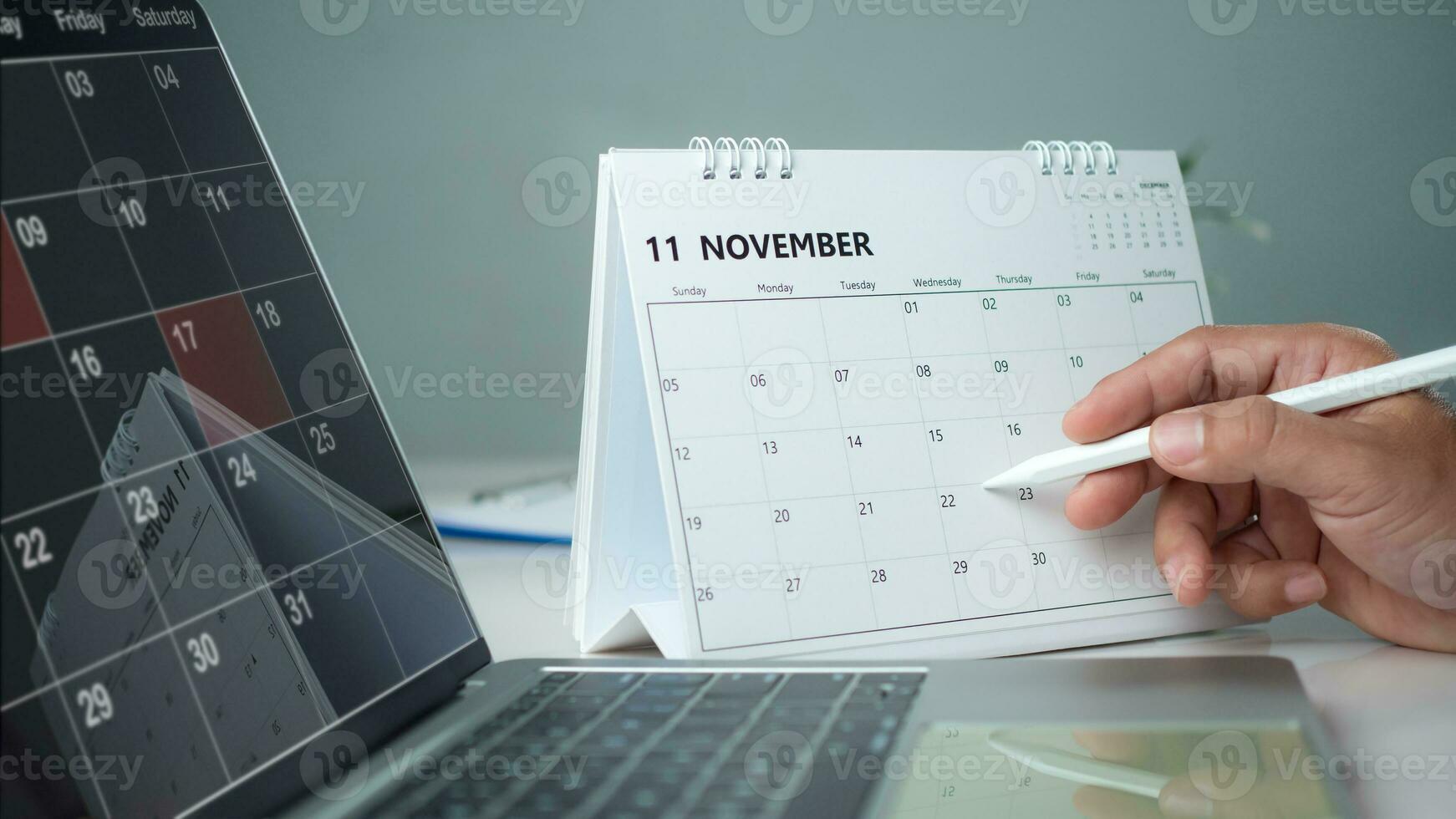 Businessman marking dates on calendar, managing his business schedule, setting reminders for important appointments, creative collage for planning ideas, appointment scheduler photo