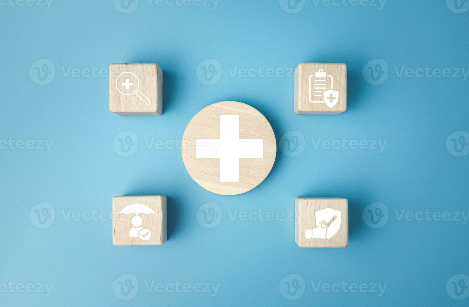 Concept of health insurance and medical. Wooden block with icons about health insurance and access to health care, health care planning on a blue background. photo